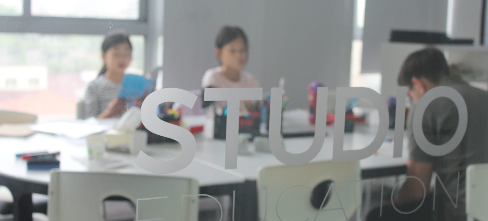 A Studio class seen through the frosted Studio Education glass